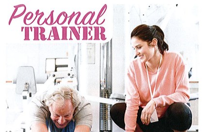 A personal trainer helping a client at the gym